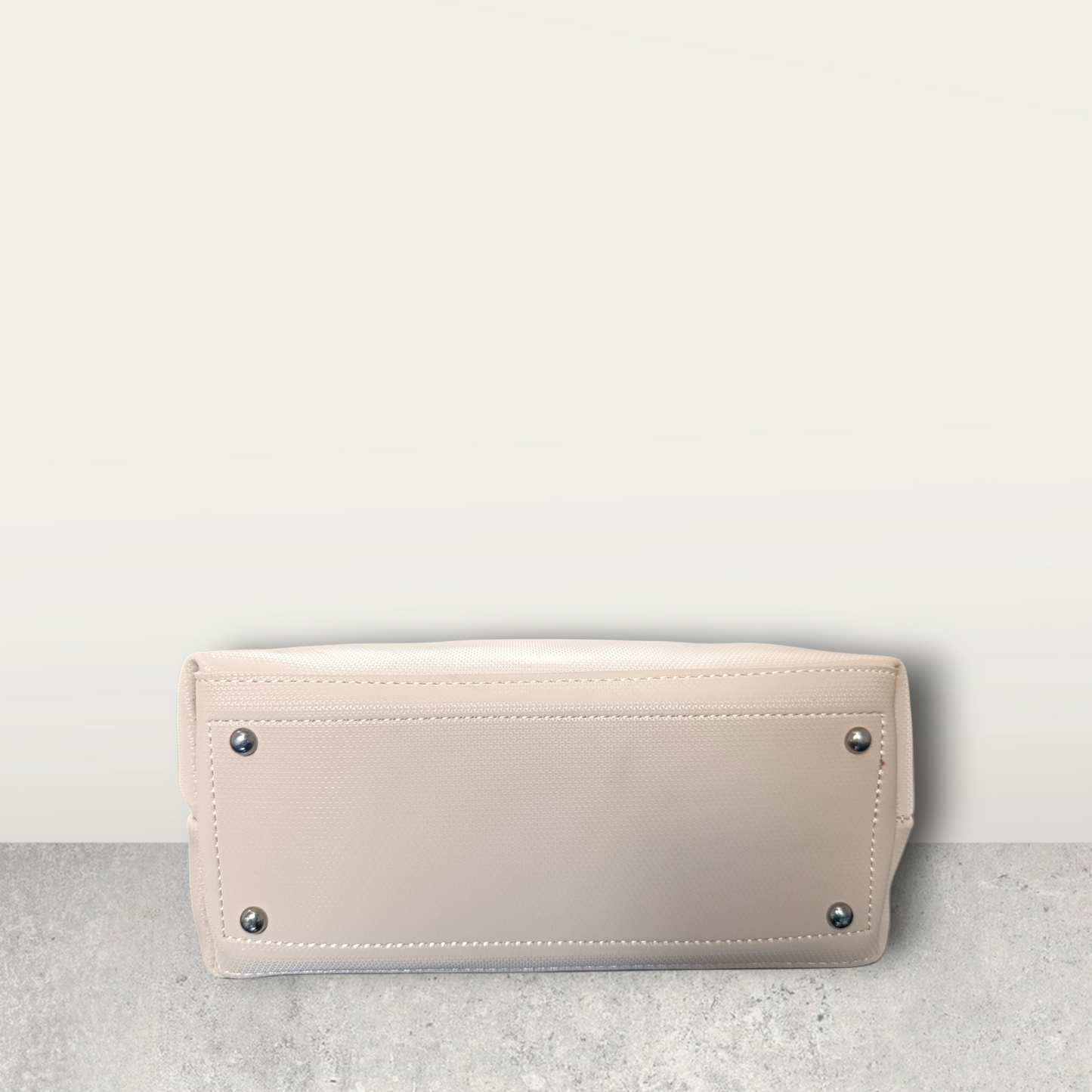 Chic Nude Perforated Tote with Tassel Charm