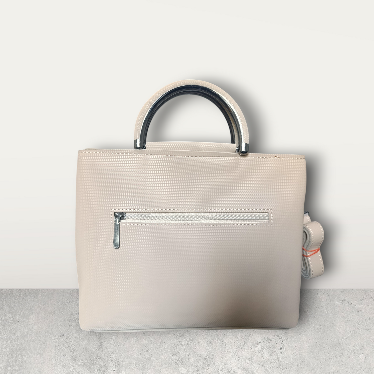 Chic Nude Perforated Tote with Tassel Charm