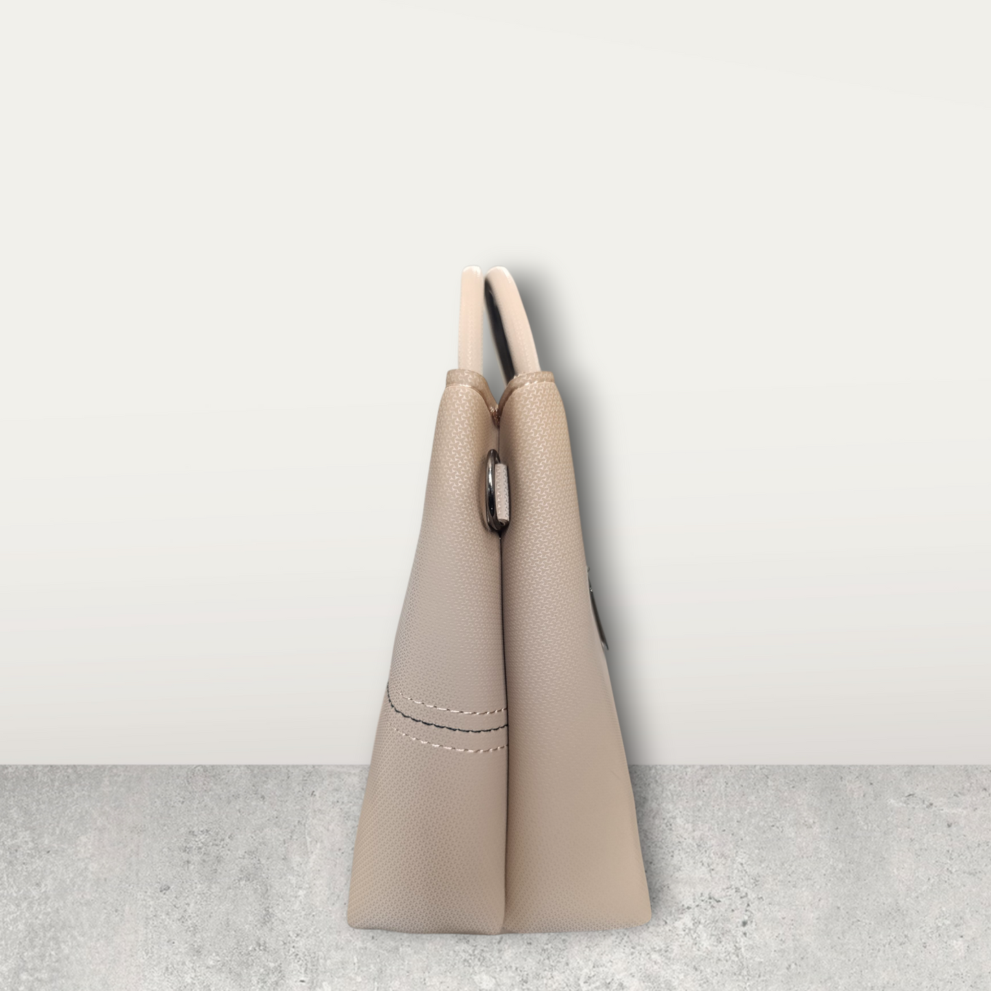 Chic Nude Perforated Tote with Tassel Charm