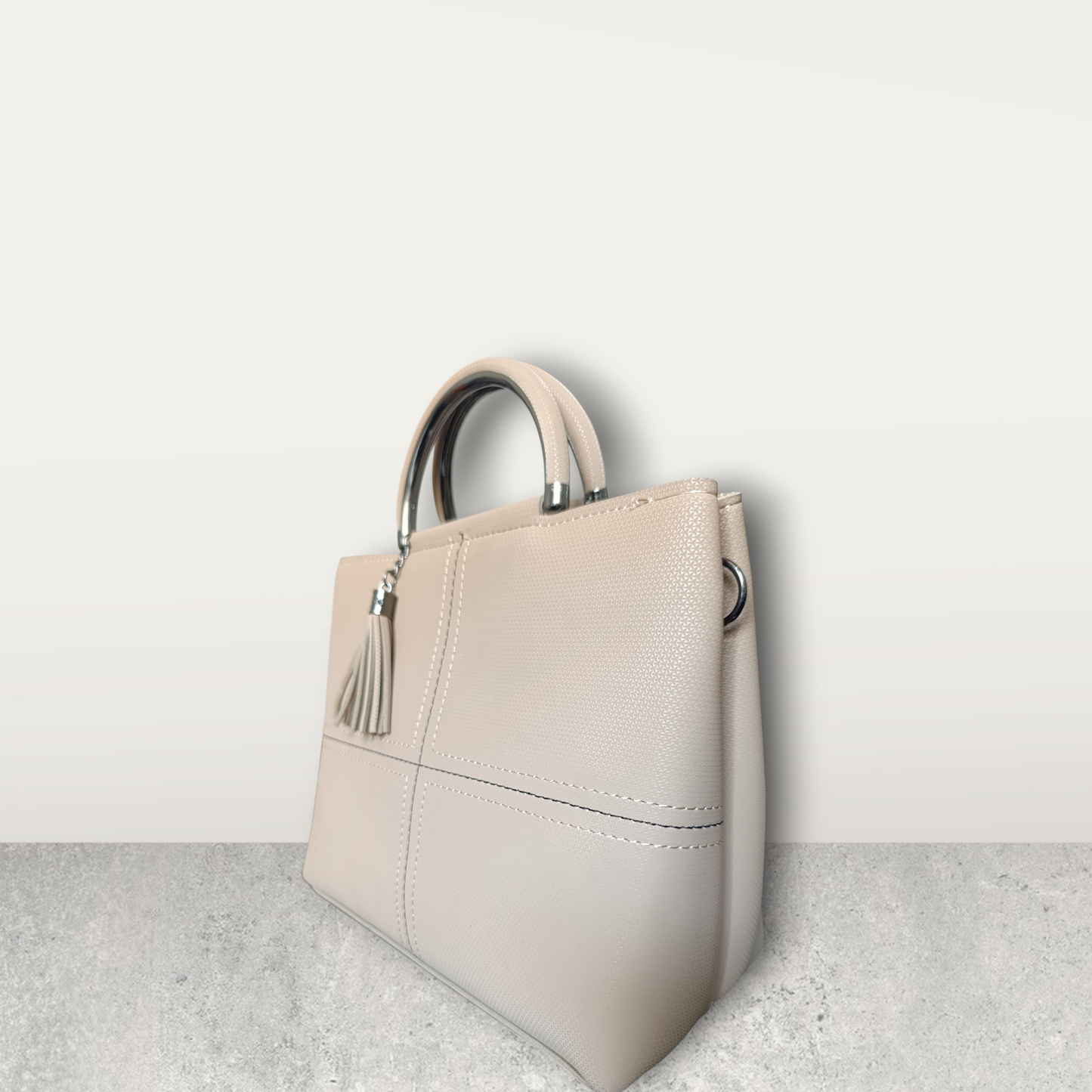 Chic Nude Perforated Tote with Tassel Charm